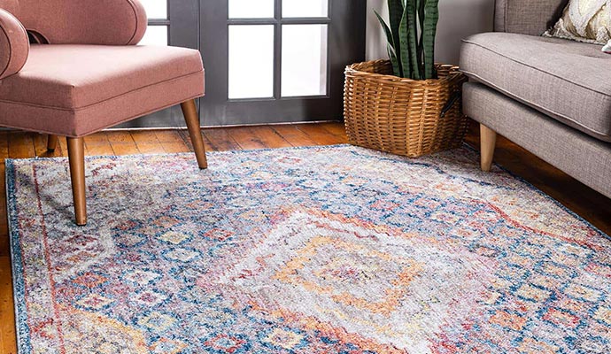 A stylish living room featuring a persian-style rug on a hardwood floor
