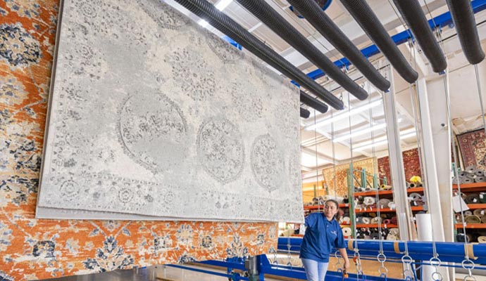 Area rugs hanging to dry after professional cleaning service