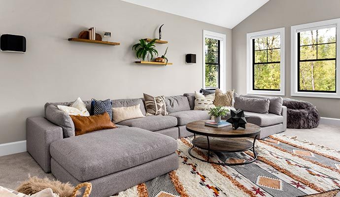 Clean patterned rug placed in a living room Clean patterned rug placed under a sofa in a cozy living room interior