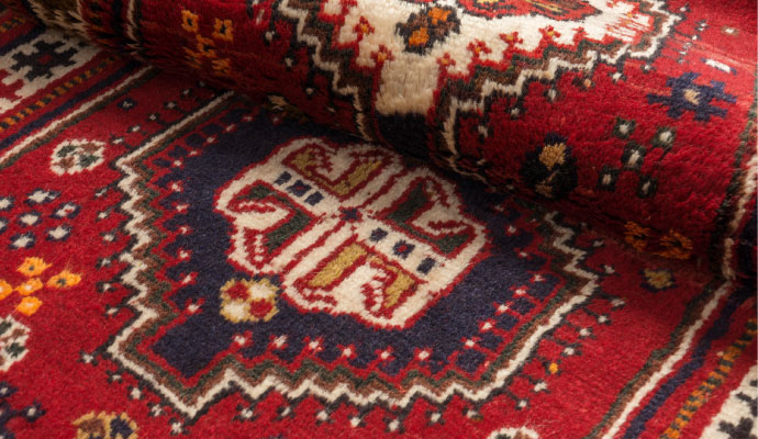 A close-up view of a vibrant red persian rug
