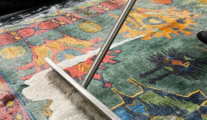 Close-up of a colorful rug being cleaned