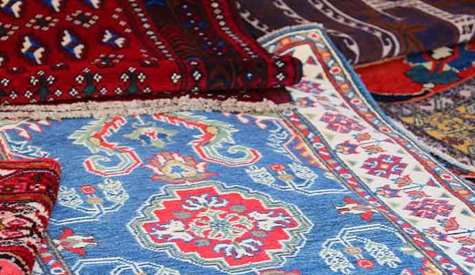 Close-up of colorful patterned area rugs with decorative borders