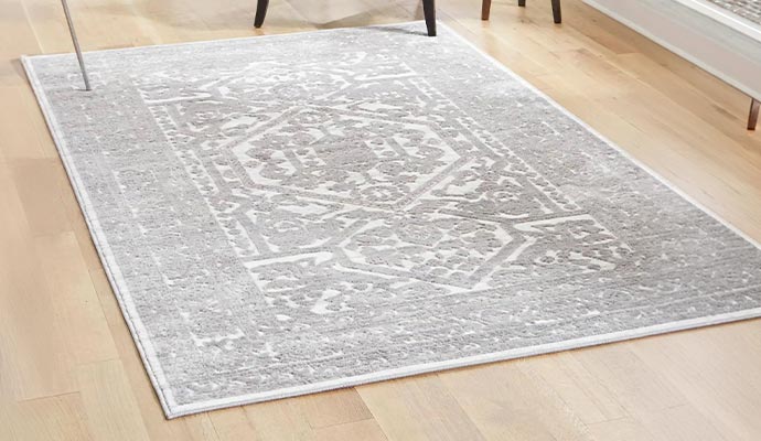 Gray distressed medallion area rug on hardwood