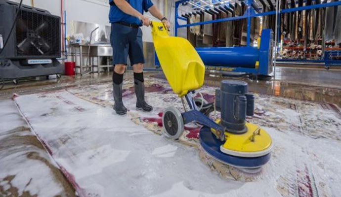 Floor cleaning machine being used on a wet industrial floor