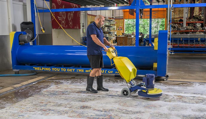 Professional cleaning area rug with industrial scrubber
