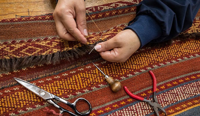 Professional worker repairing rug