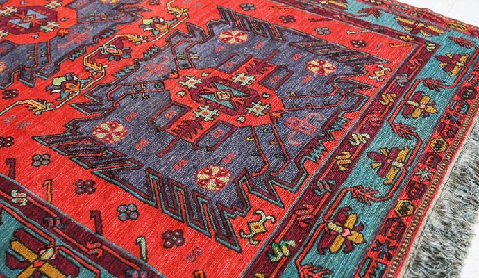 Close-up of a red patterned Turkish rug with decorative border