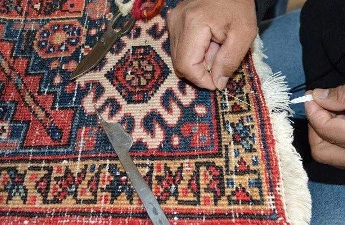 Professional worker repairing a rug