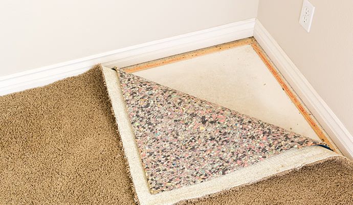 Rug pad installed under carpet for added comfort