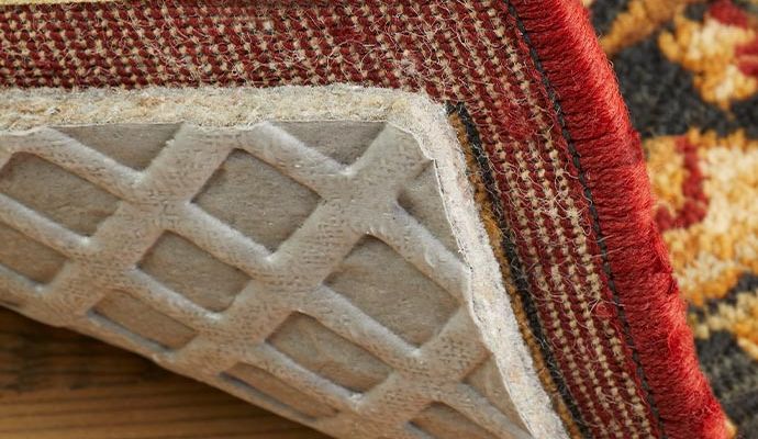 Rug pad visible at the corner of the rug