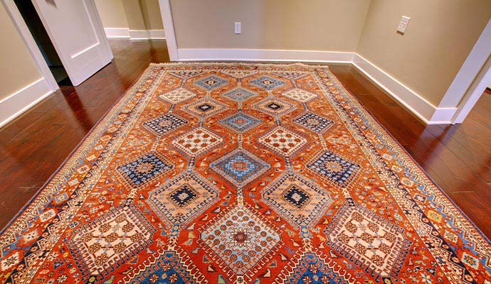 Antique patterned area rug on dark hardwood floor