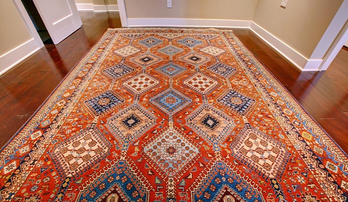 Traditional Persian area rug on hardwood floor