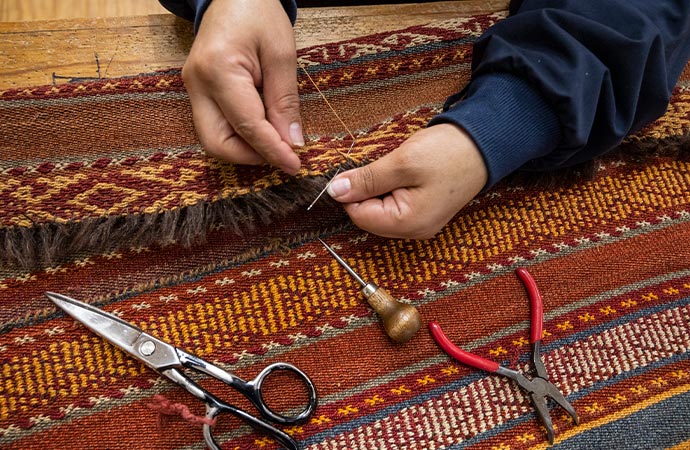Worker repairing rug