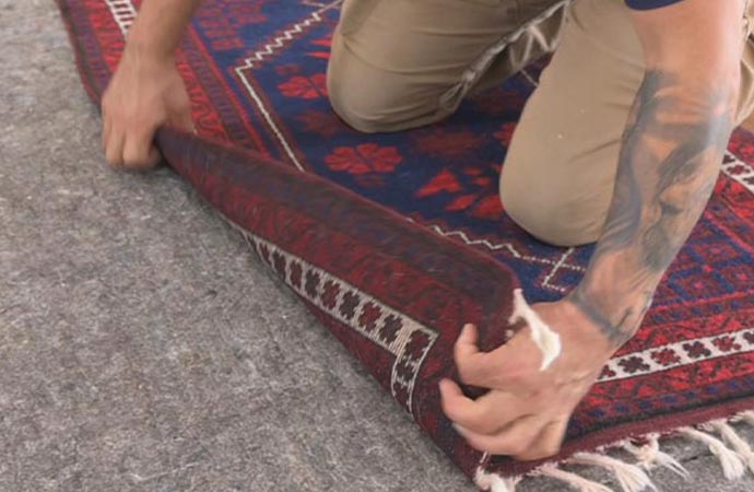 worker replacing rug pad